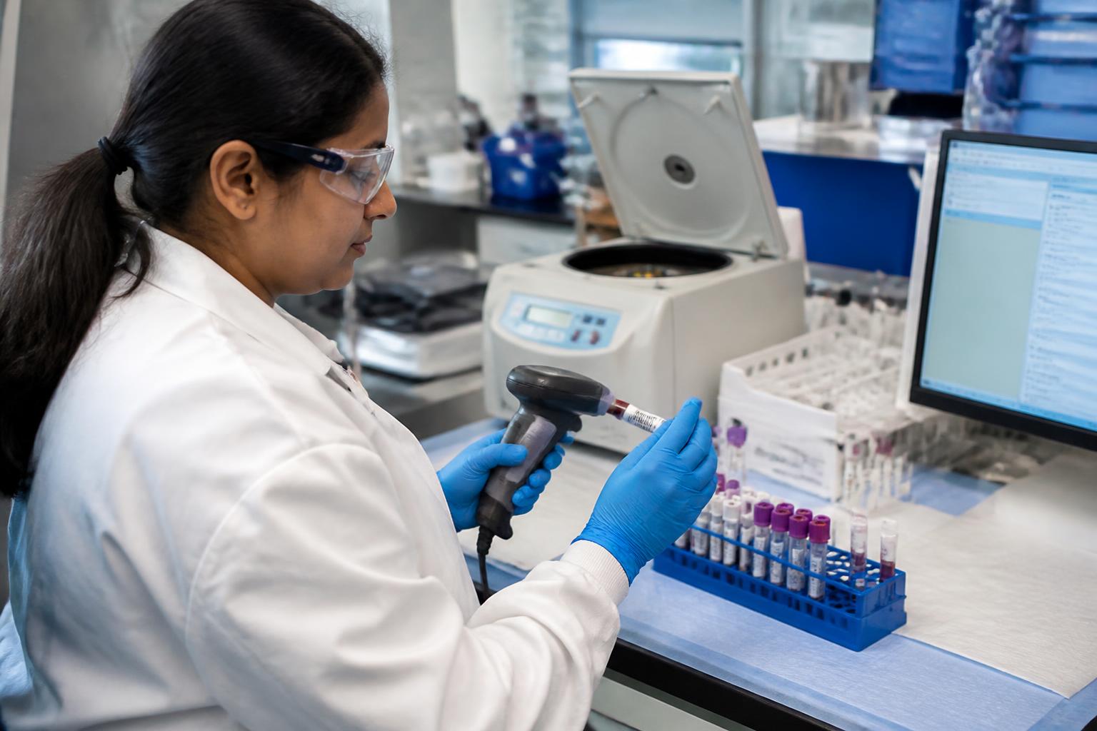 Laboratory scientist accessioning barcoded clinical specimens